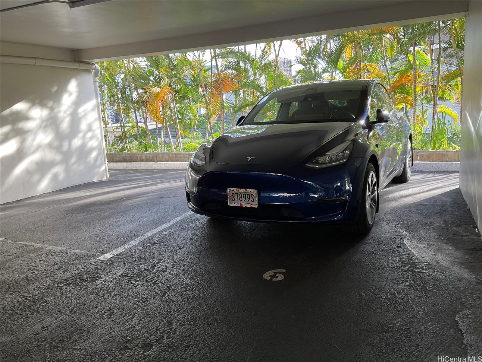 1019 Maunaihi Place, Unit 203 Honolulu, HI 96822 - Photo 17 of 19 a car parked in the back yard