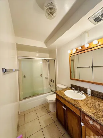 a bathroom with a granite countertop sink a mirror and a shower