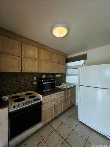 a kitchen with a stove and a refrigerator