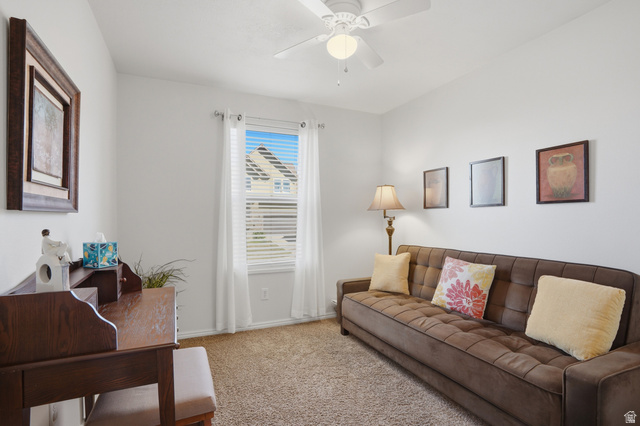 7737 Ranches Parkway Eagle Mountain, UT 84005 - Photo 16 of 28 Bright interior space featuring a window with blinds, carpeted flooring, a ceiling fan with integrated lighting, and neutral wall tones