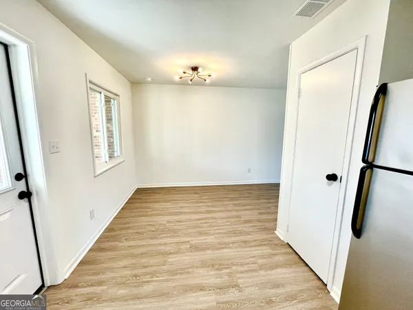 a view of a kitchen with microwave and furniture