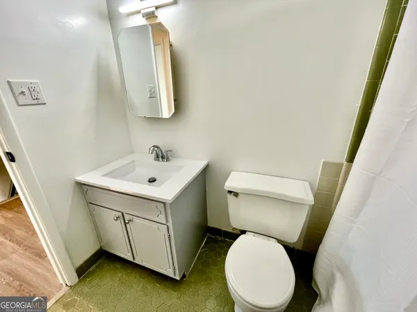 a view of a house with large windows and a tree