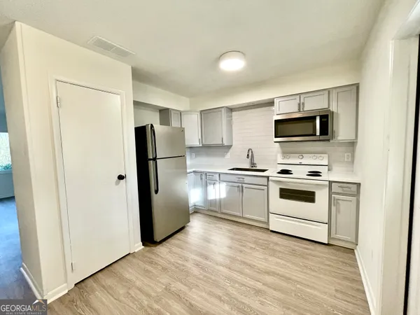 a stove top oven sitting inside of a kitchen