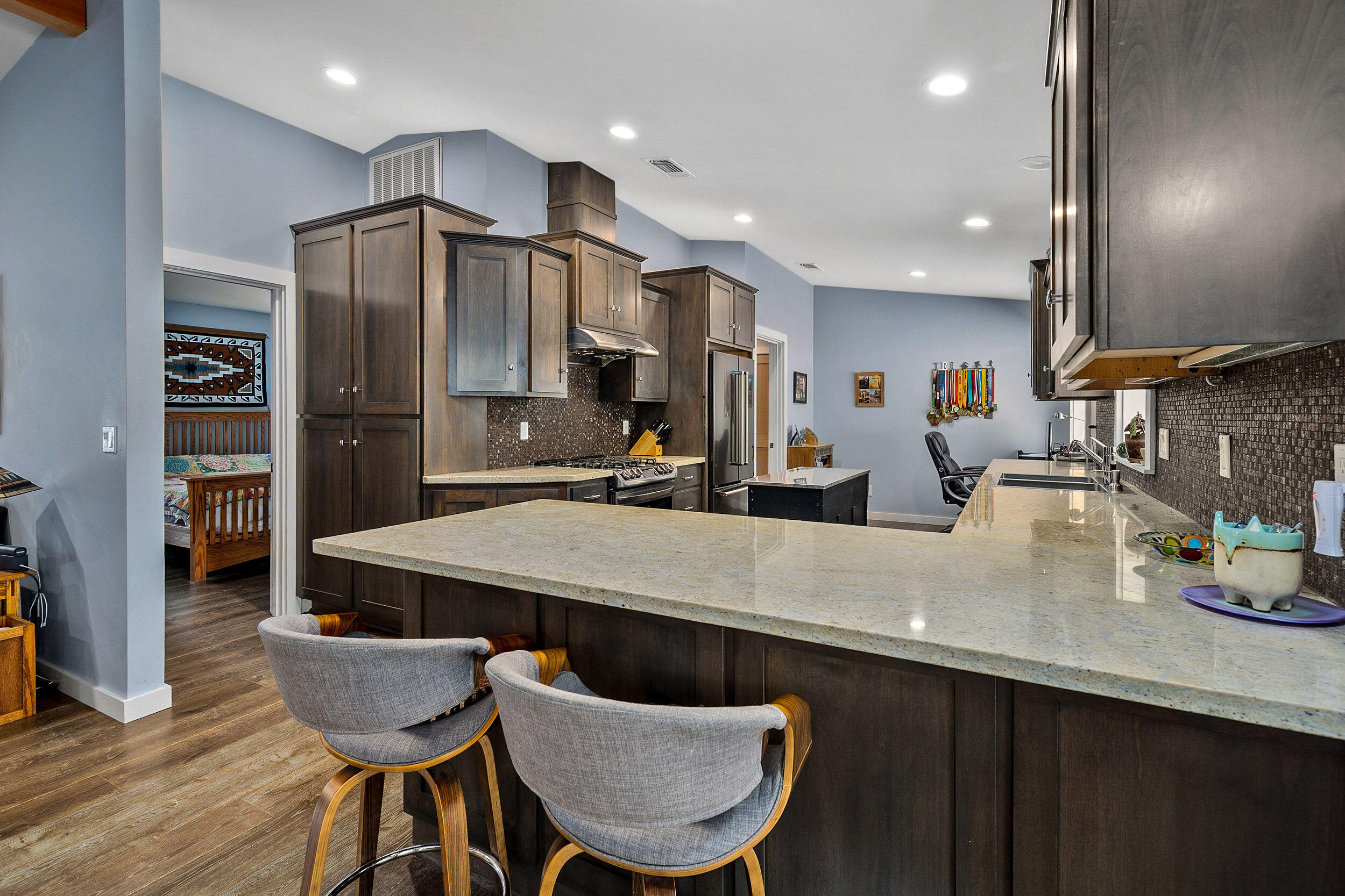 3425 Quartz Creek Road Merlin, OR 97532 - Photo 15 of 41 a kitchen with granite countertop a table chairs refrigerator and microwave