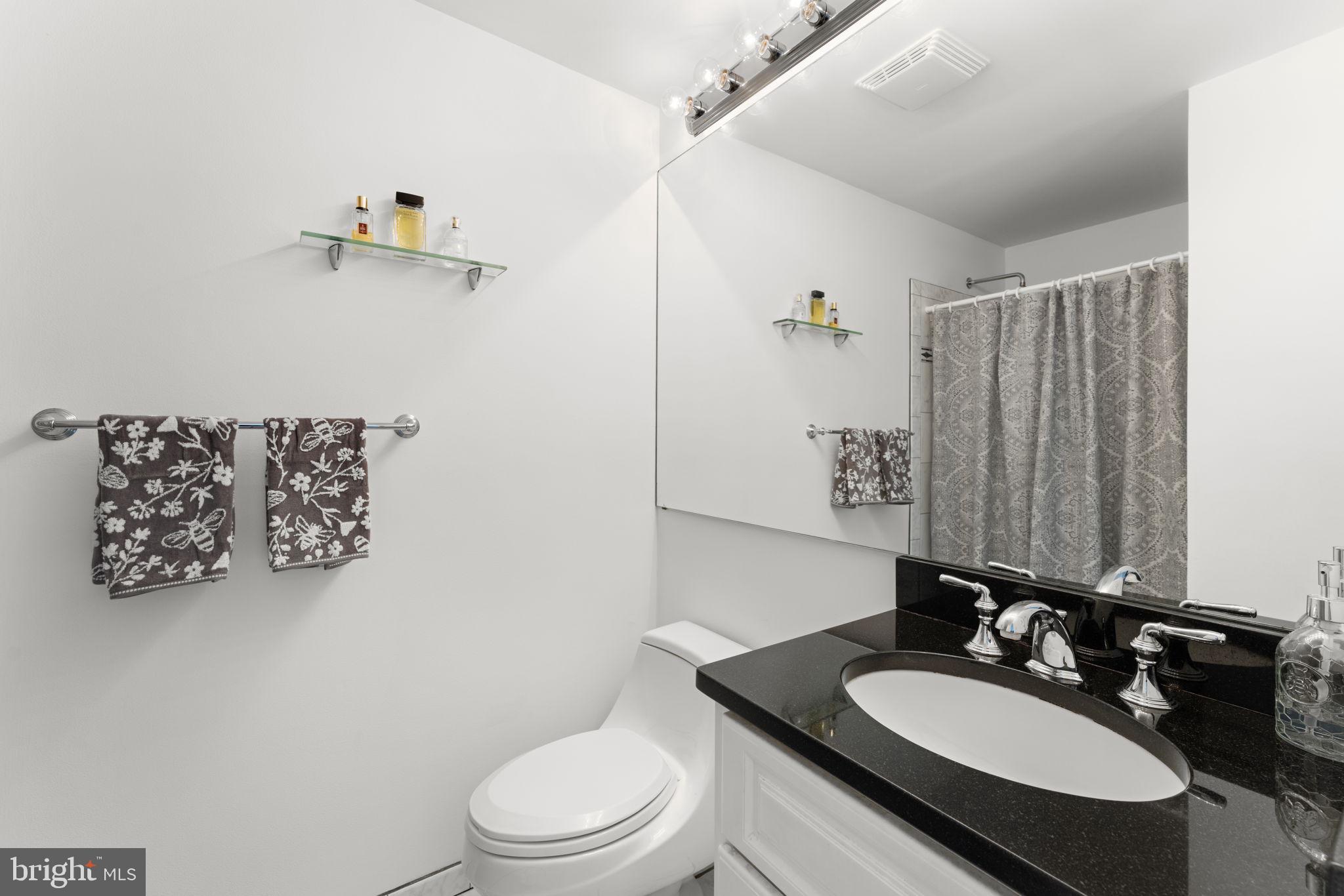 9801 Pulham Road Burke, VA 22015 - Photo 27 of 63 a bathroom with a granite countertop sink mirror vanity and toilet