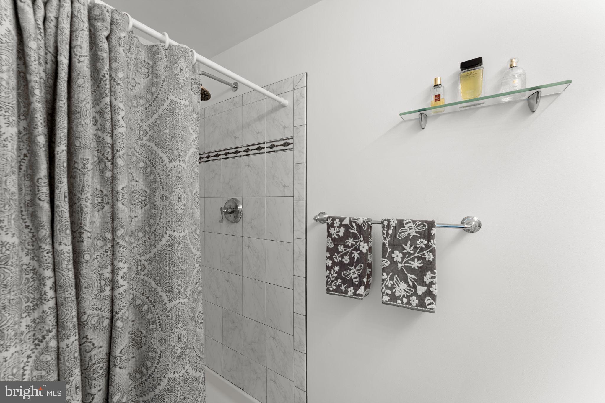 9801 Pulham Road Burke, VA 22015 - Photo 28 of 63 a bathroom with a shower and a shower curtain
