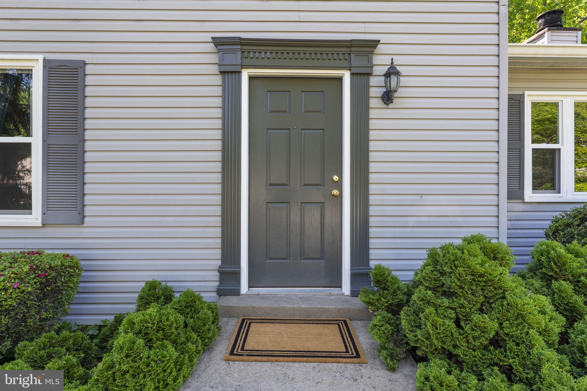 9801 Pulham Road Burke, VA 22015 - Photo 4 of 63 a front view of a house with a yard and garage