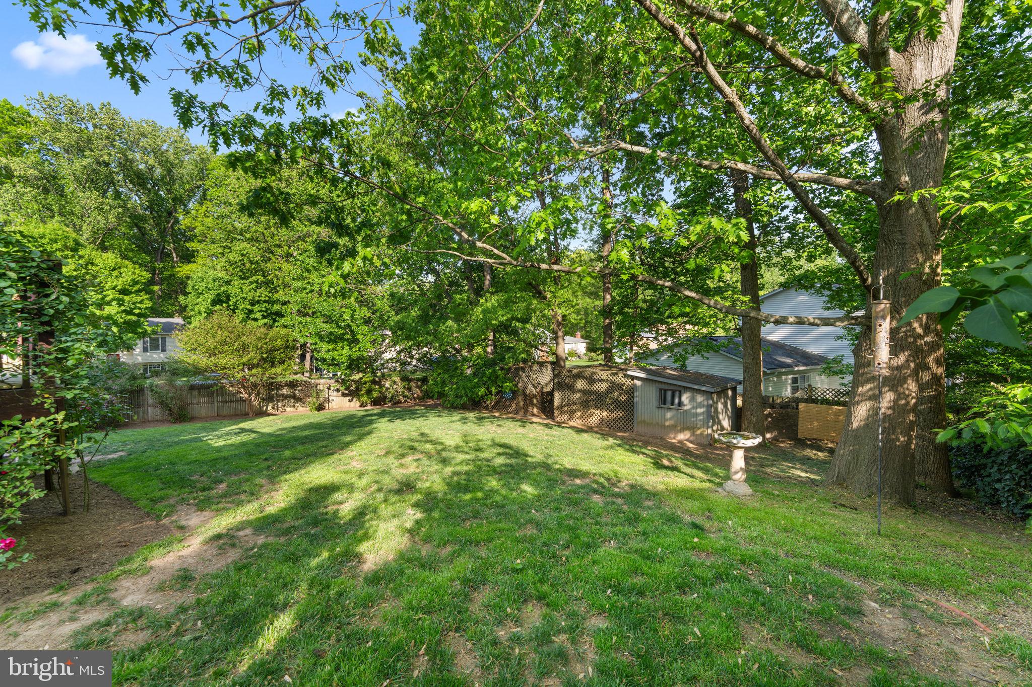 9801 Pulham Road Burke, VA 22015 - Photo 42 of 63 a backyard of a house with table and chairs
