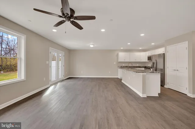 a view of kitchen with sink and wooden floor