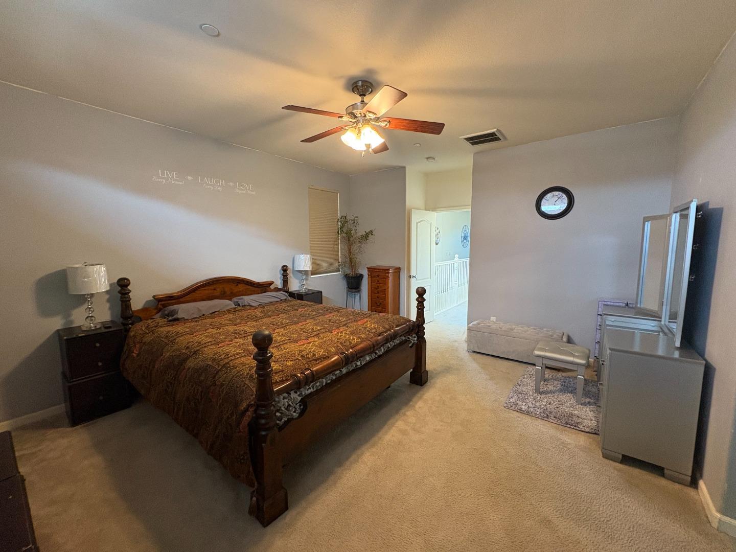 51 Sturla Way Gilroy, CA 95020 - Photo 13 of 27 a bedroom with a bed and a chandelier