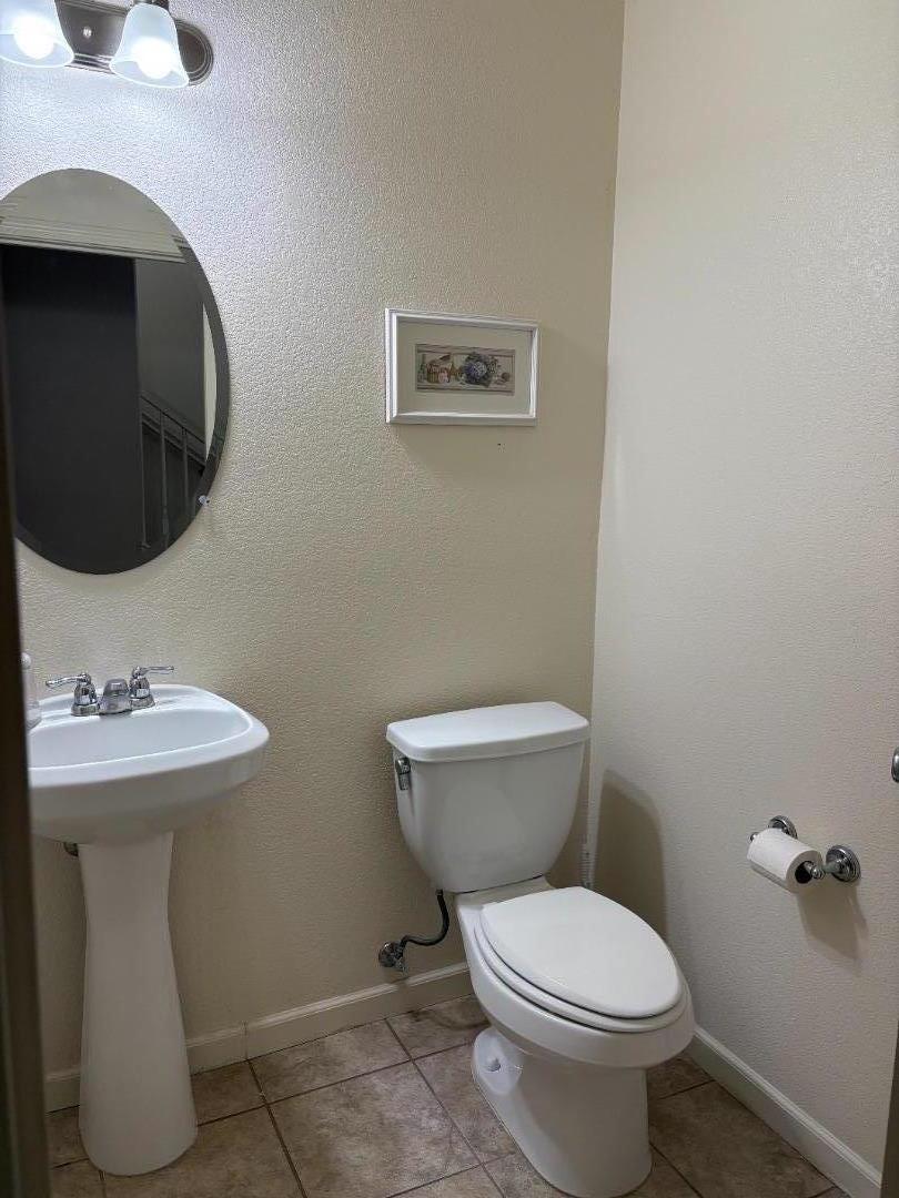 51 Sturla Way Gilroy, CA 95020 - Photo 22 of 27 a white toilet sitting next to a bathroom sink