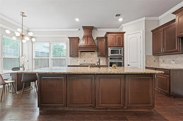 a kitchen with lots of counter top space and wooden floor