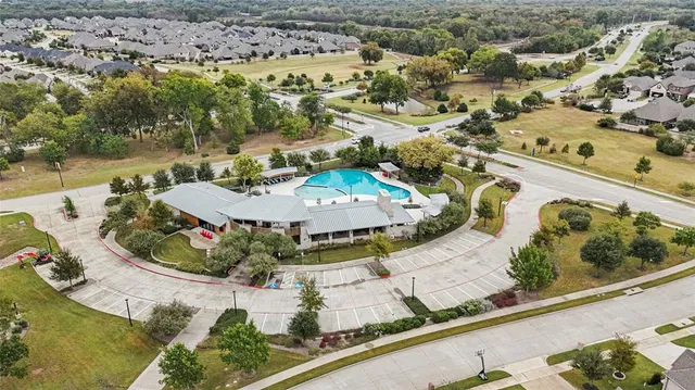 an aerial view of a house with a swimming pool