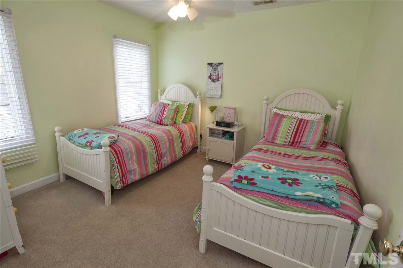 2609 Kittrell Drive Raleigh, NC 27608 - Photo 13 of 25 a bedroom with two beds and a chandelier