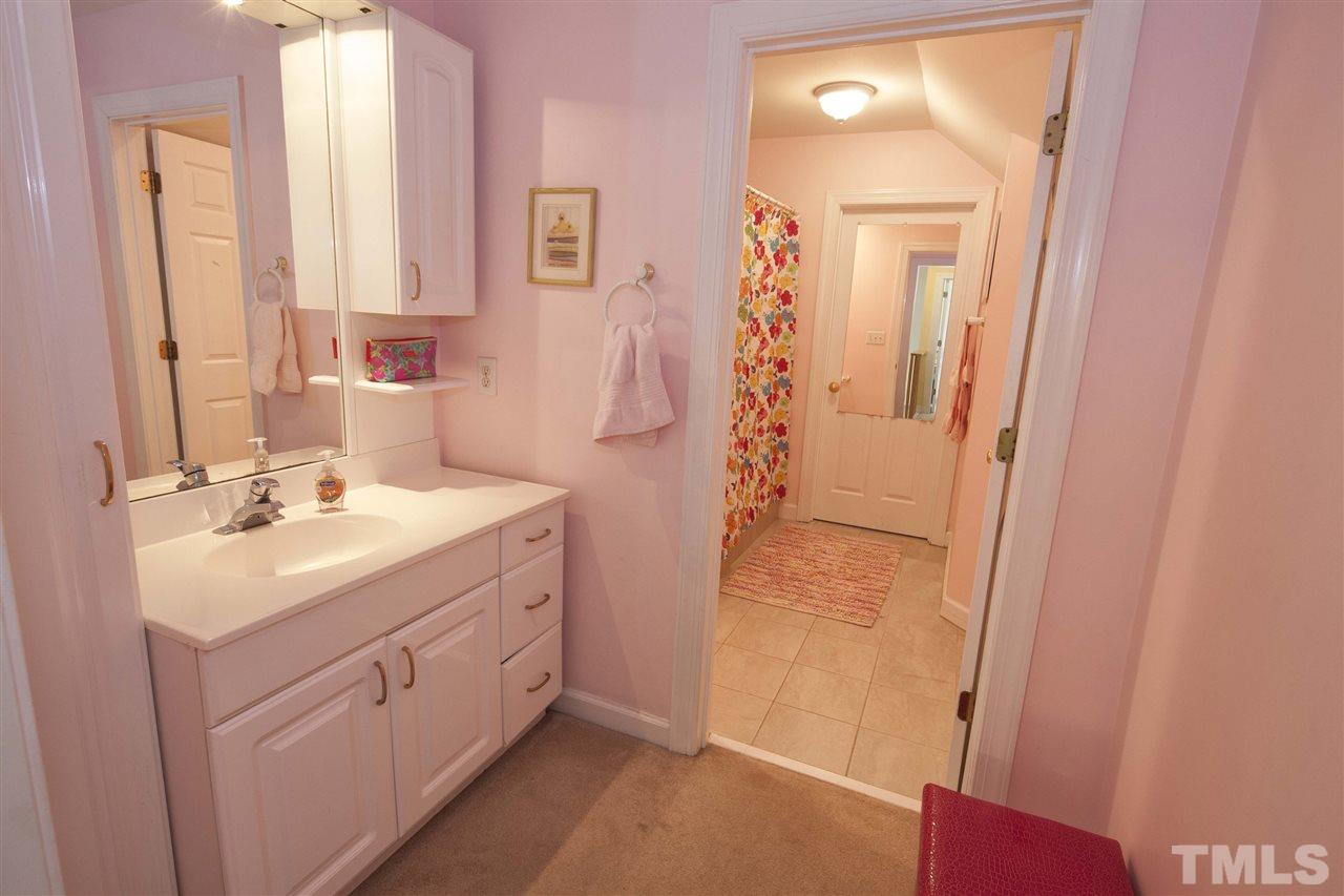 2609 Kittrell Drive Raleigh, NC 27608 - Photo 15 of 25 a bathroom with a sink a mirror and a shower