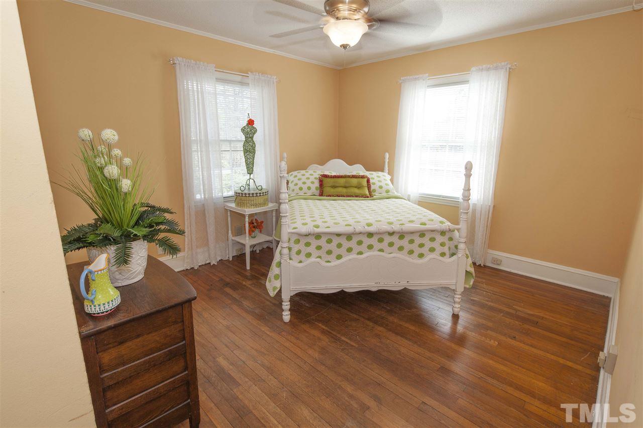 2609 Kittrell Drive Raleigh, NC 27608 - Photo 18 of 25 a bedroom with a bed table and a window