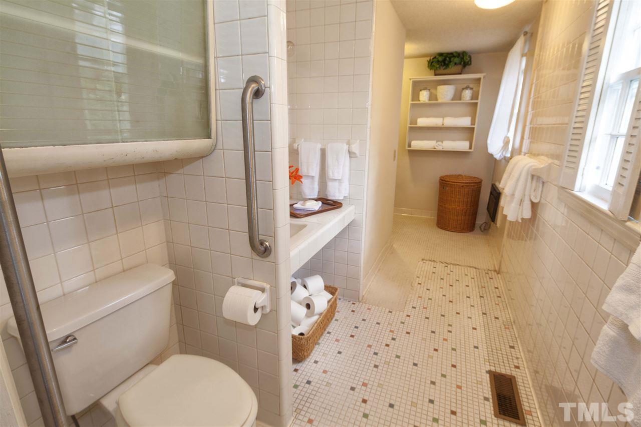 2609 Kittrell Drive Raleigh, NC 27608 - Photo 19 of 25 a bathroom with a sink toilet and shower