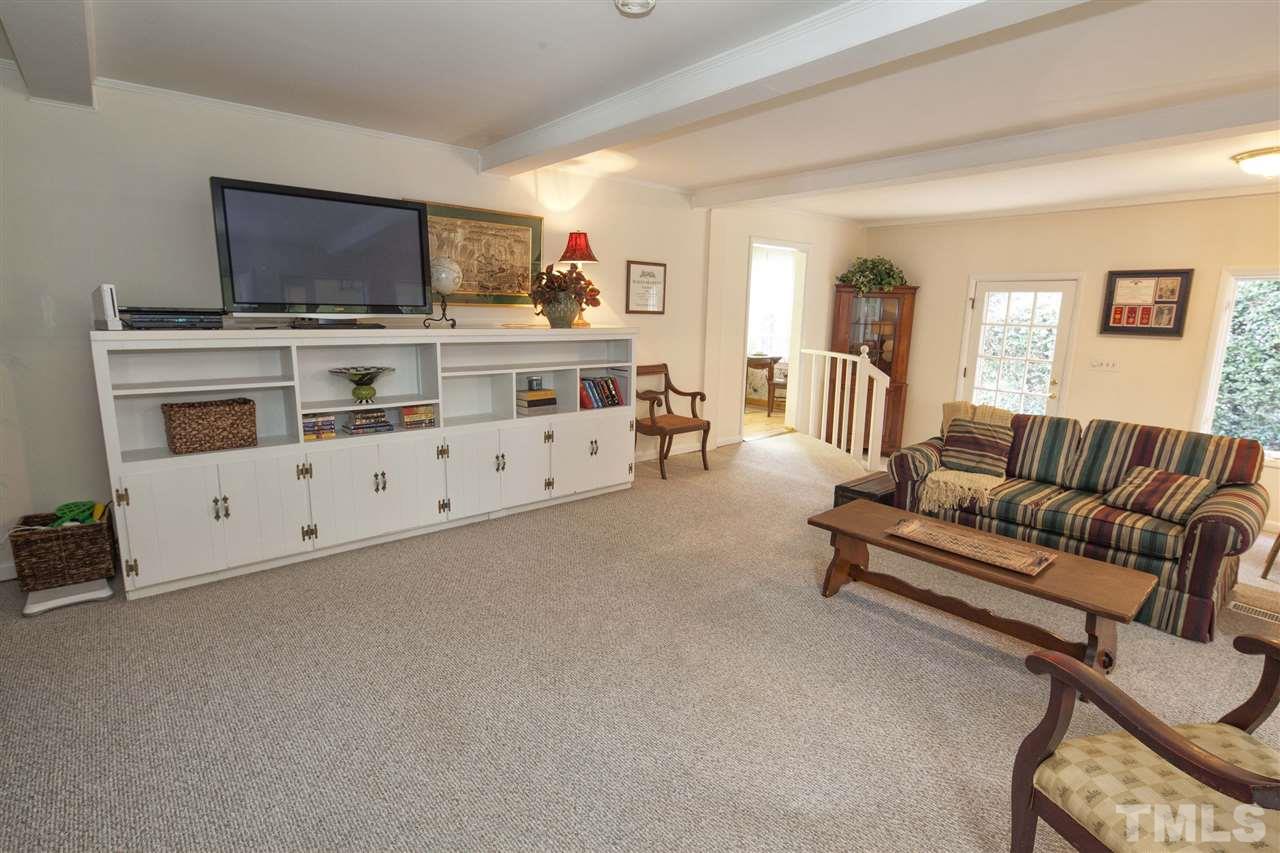 2609 Kittrell Drive Raleigh, NC 27608 - Photo 24 of 25 a living room with furniture and a flat screen tv