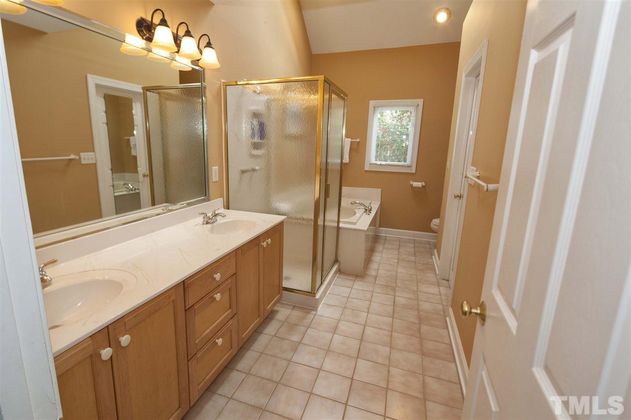 2609 Kittrell Drive Raleigh, NC 27608 - Photo 25 of 25 a spacious bathroom with a double vanity sink a mirror and a shower