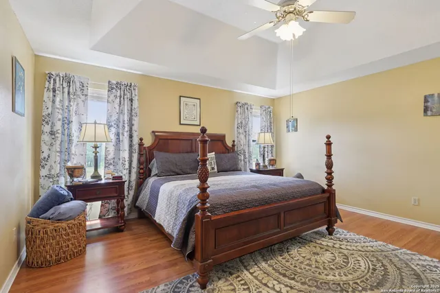 a bedroom with bed and wooden floor