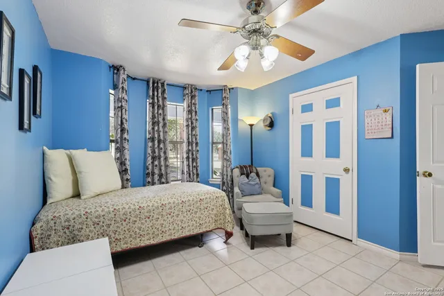 a bedroom with a bed and ceiling fan