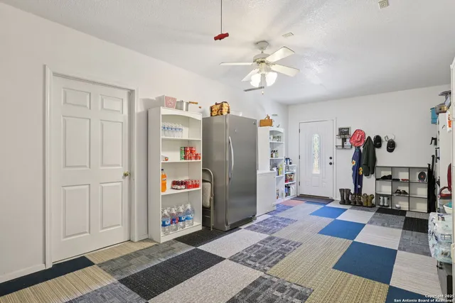 a view of a workspace with furniture and wooden floor