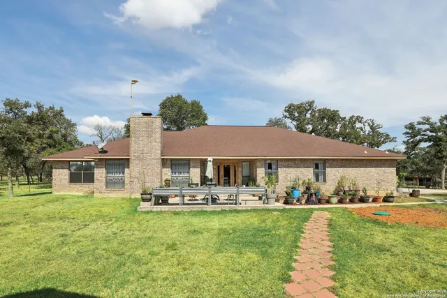 a front view of a house with a yard table and chairs