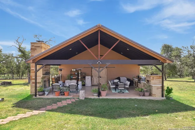 a view of a patio with table and chairs under an umbrella