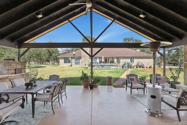 a patio with a table chairs and a umbrella