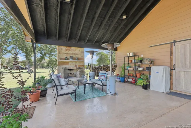 a view of a porch with furniture and garden view