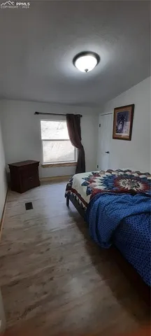 a view of a living room with furniture and wooden floor
