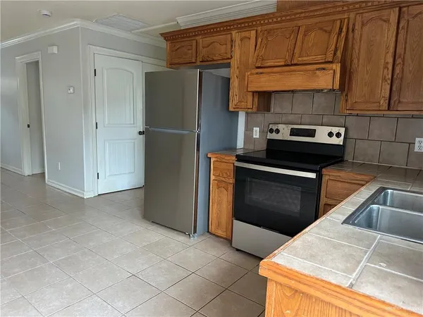 a kitchen with stainless steel appliances granite countertop a refrigerator and a stove