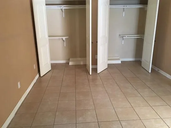 a view of a room with a refrigerator and cabinet