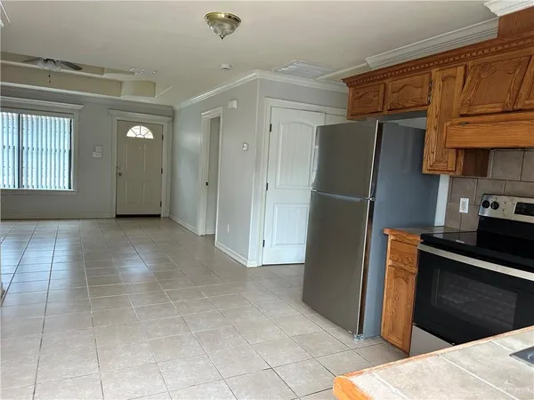 a kitchen with stainless steel appliances granite countertop a refrigerator and a stove