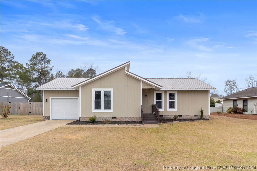 4108 Mill Bridge Road Hope Mills, NC 28348 - Photo 1 of 27 a front view of house with yard and trees in the background