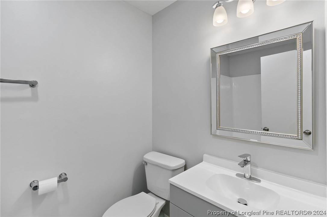 4108 Mill Bridge Road Hope Mills, NC 28348 - Photo 14 of 27 a bathroom with a sink mirror and toilet