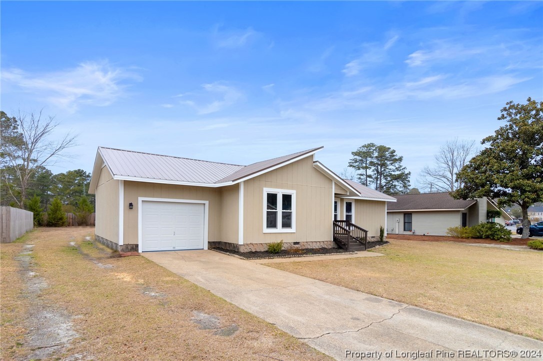 4108 Mill Bridge Road Hope Mills, NC 28348 - Photo 2 of 27 a front view of a house with a yard and garage