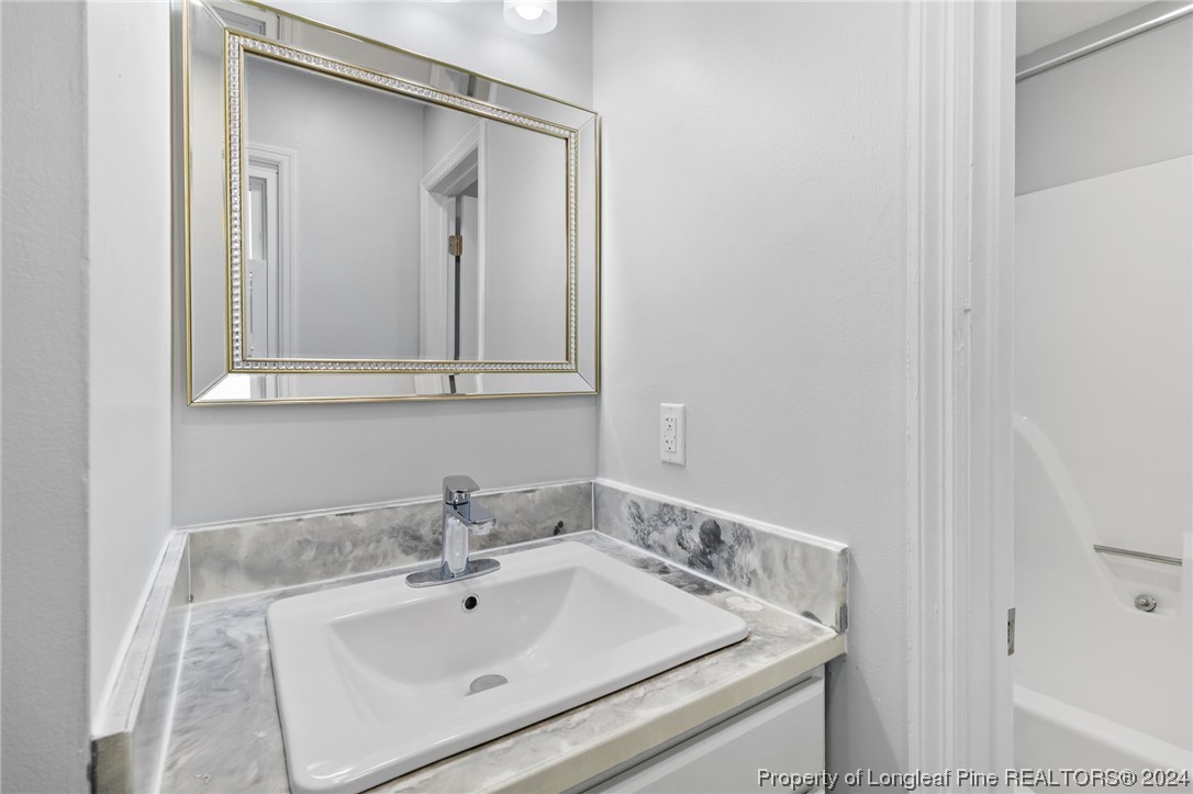 4108 Mill Bridge Road Hope Mills, NC 28348 - Photo 21 of 27 a bathroom with a sink and vanity
