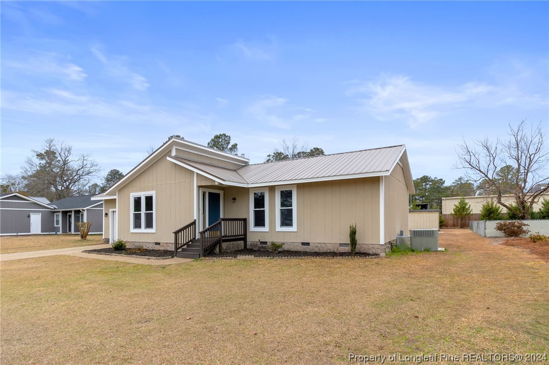 4108 Mill Bridge Road Hope Mills, NC 28348 - Photo 3 of 27 a view of a house with a backyard