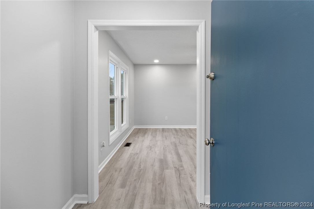 4108 Mill Bridge Road Hope Mills, NC 28348 - Photo 4 of 27 a view of a hallway with wooden floor
