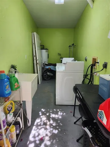 a view of a patio with chairs and potted plants