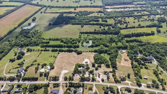 an aerial view of a house with a yard and lake view