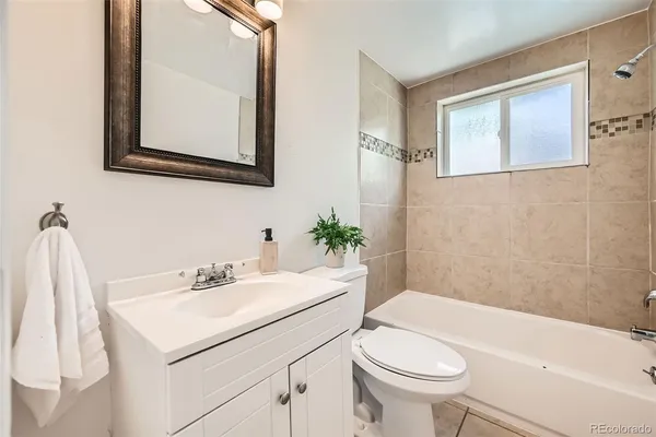 a bathroom with a sink toilet and a mirror