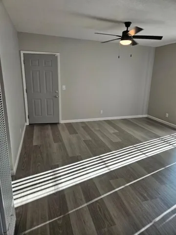 a view of a ceiling fan and wooden floor
