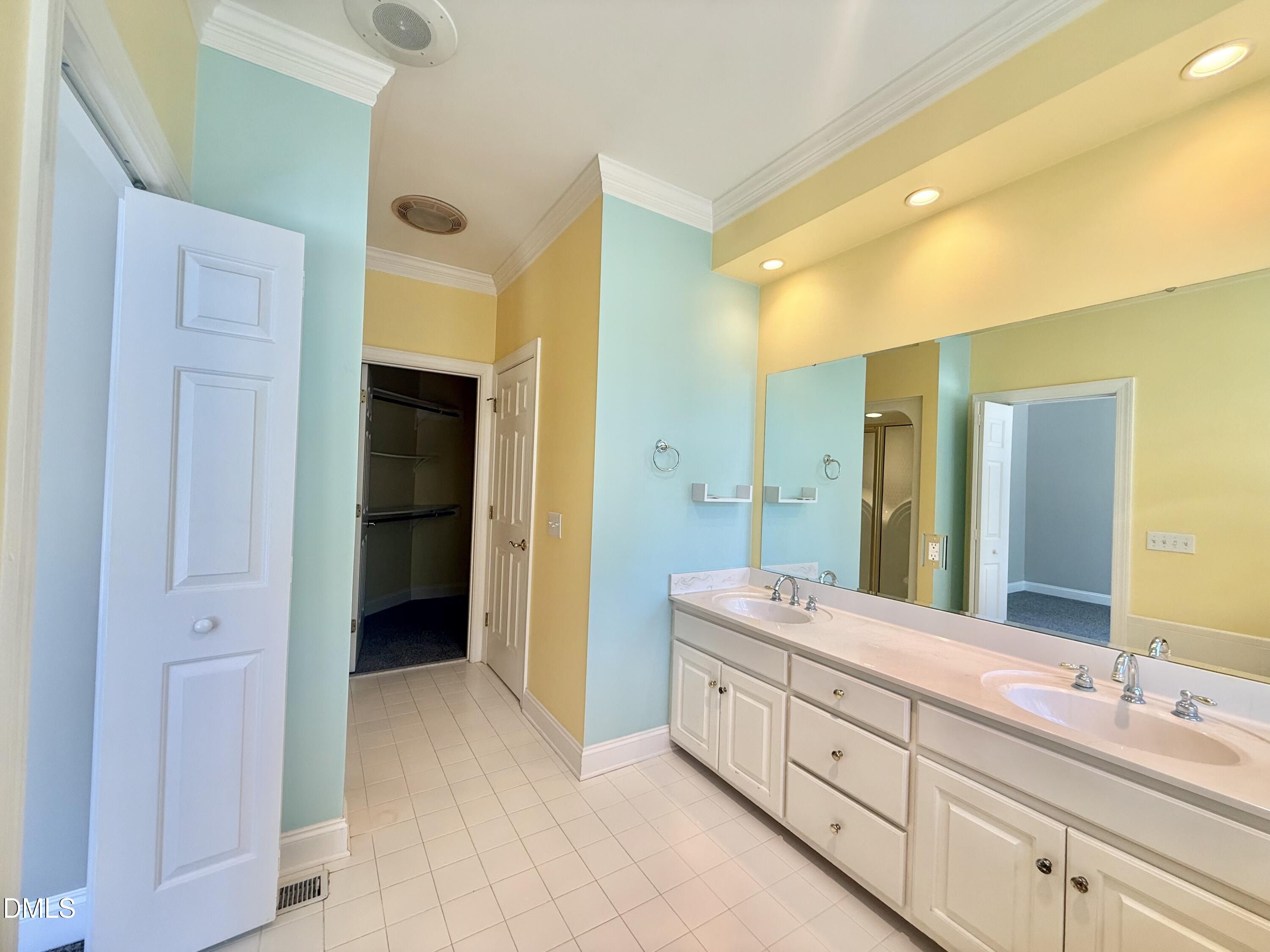 81 Beaver Crossing Road Roxboro, NC 27574 - Photo 29 of 80 a spacious bathroom with a double vanity sink a large mirror and a shower