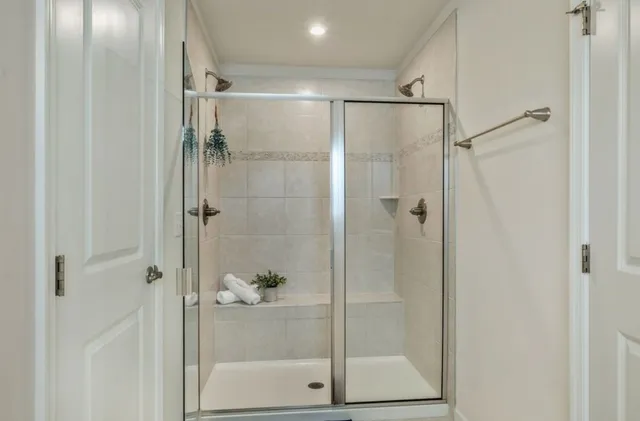 a bathroom with a glass shower door