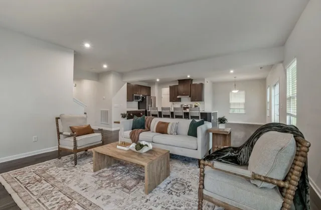 a living room with furniture and wooden floor