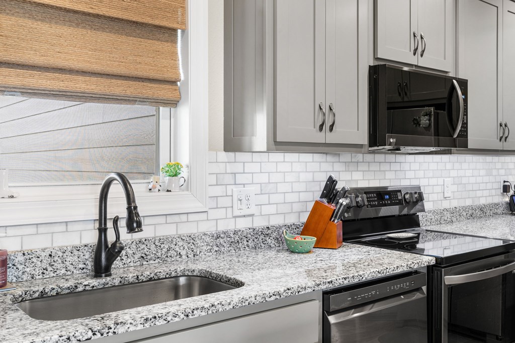 958 New Forest Road Young Harris, GA 30582 - Photo 23 of 44 a kitchen with stainless steel appliances granite countertop a sink stove and microwave