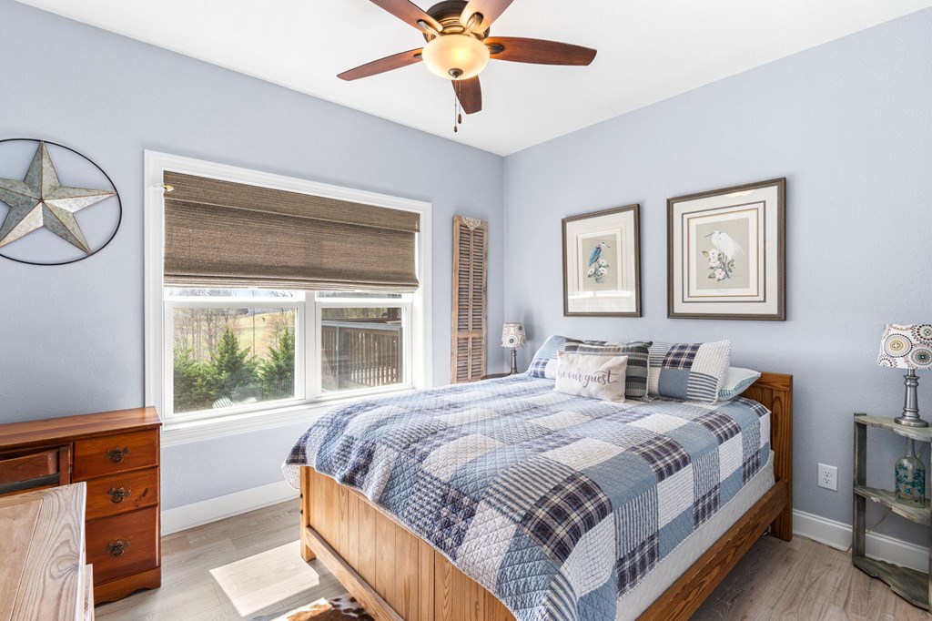 958 New Forest Road Young Harris, GA 30582 - Photo 24 of 44 a bedroom with a large bed and a window