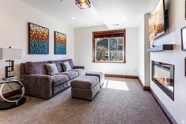 5326 North Oldgate Road Heber City, UT 84032 - Photo 19 of 32 Carpeted room featuring a built-in electric fireplace and a window with wood-finish trim